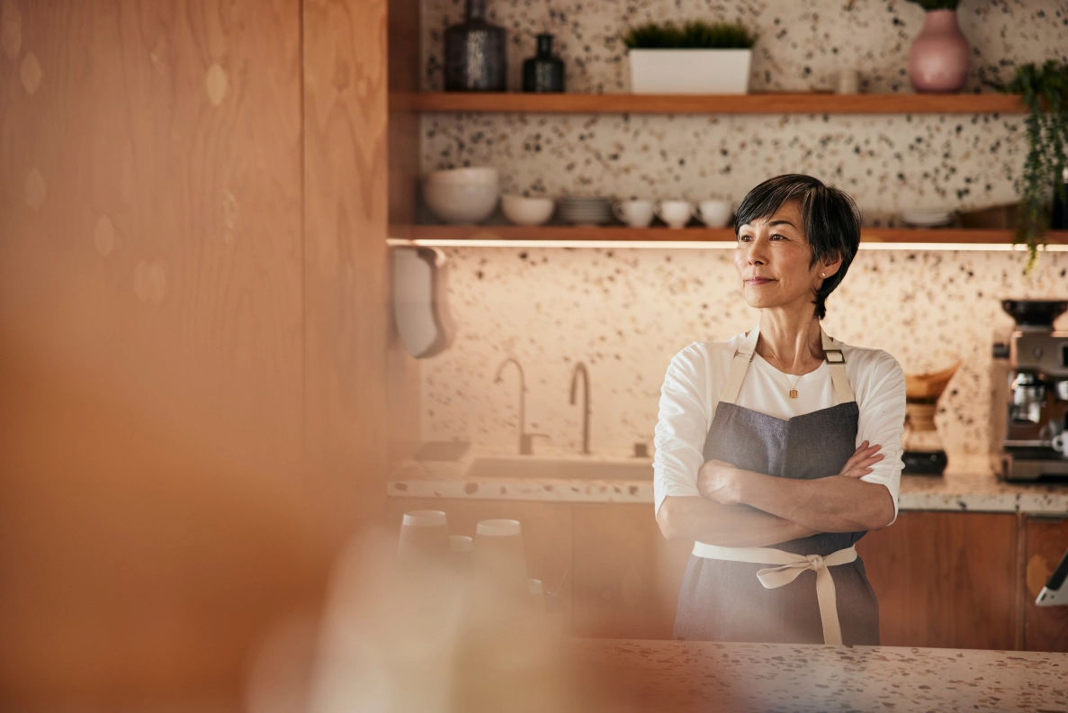 Woman behind kitchen counter